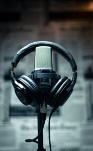 pexels-photo-3587478-3587478 Microphone with headphones in a studio environment, perfect for sound recording and podcasting.