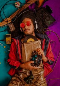 pexels-photo-3756766-3756766 Man with afro and headphones enjoying retro music surrounded by vintage items.